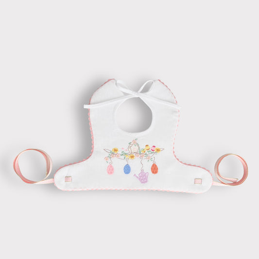 Spring Bib in Pure Linen with Pink Braided Finish and Embroidery of a Little Bird House Among Flowers and Eggs