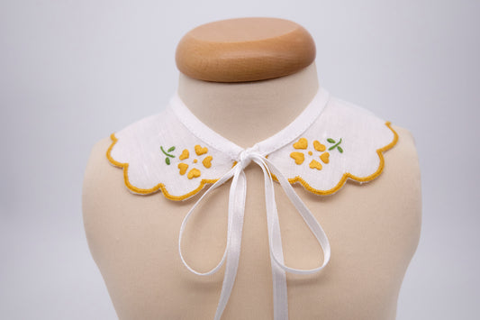 Collar in pure linen hand embroidered with ocher yellow flowers